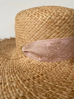 up closed detail of ribbon and riots on wide brim sun hat