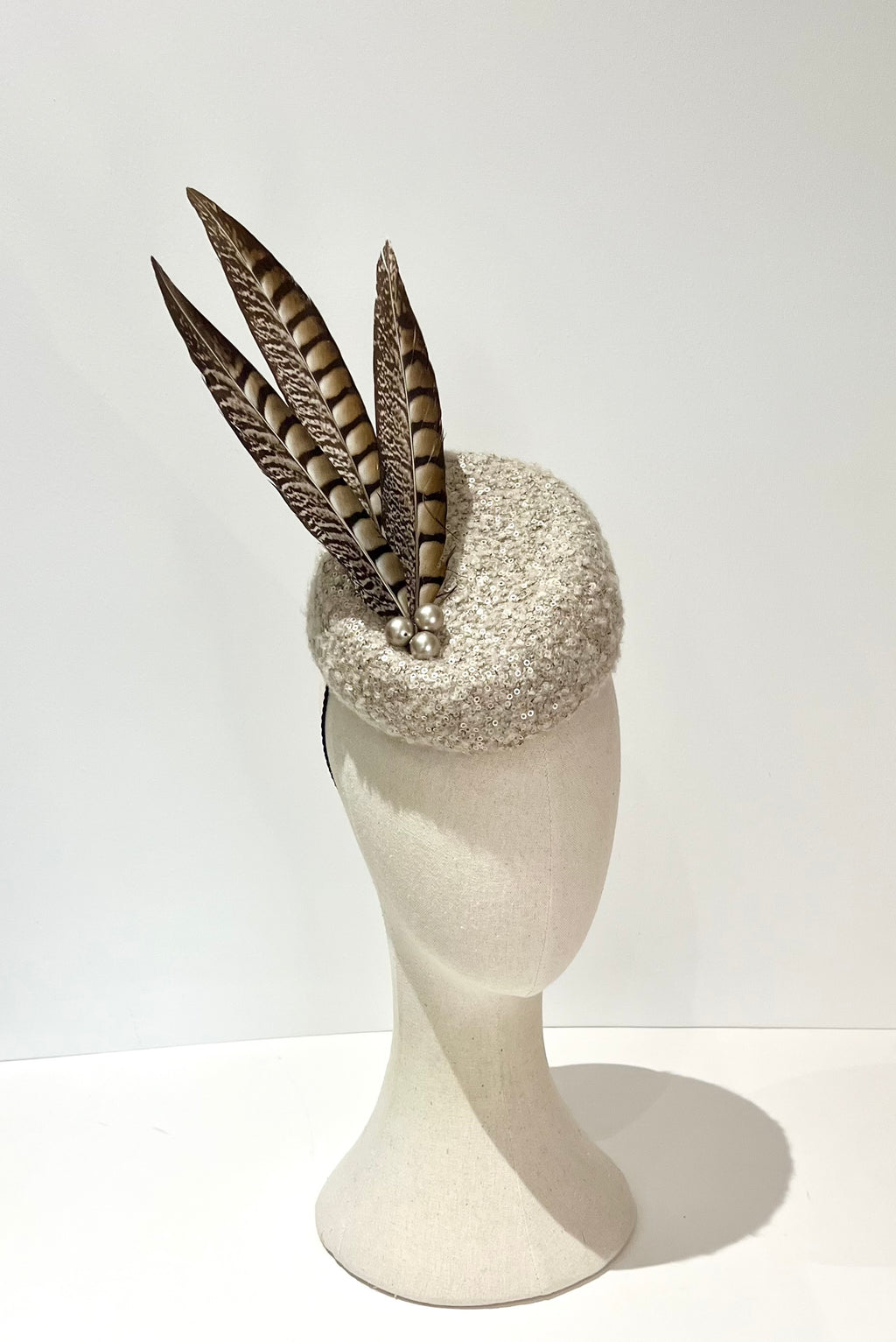 Cheltenham race hat boucle wool fabric with natural let Amherst feather 