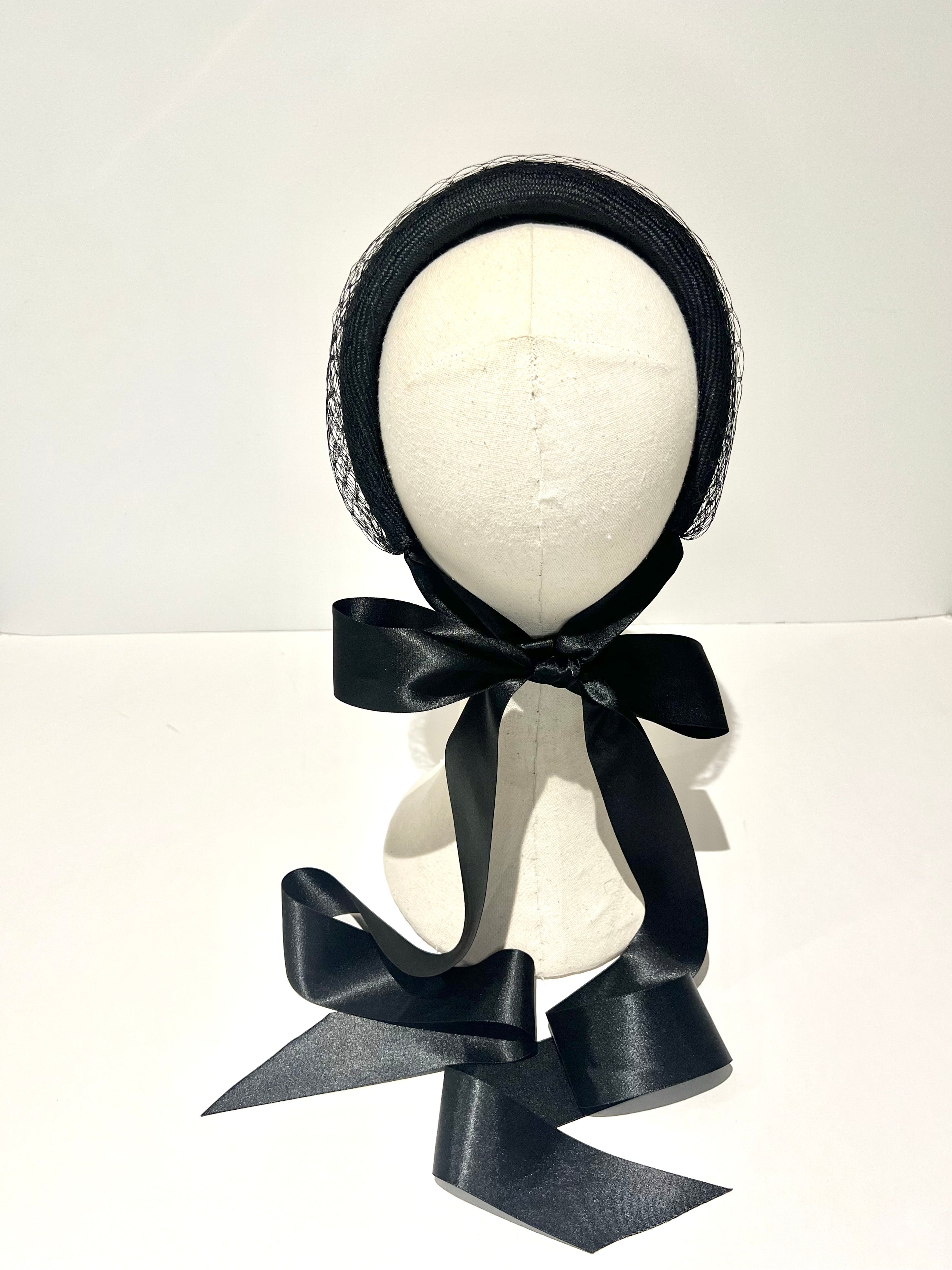 black padded halo headband with netting and black satin ribbons