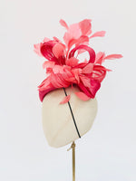 pink straw teardrop fascinator hat, with coral feather spray and silk abaca, ideal for royal ascot