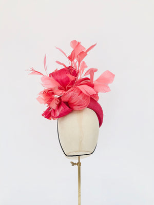 pink straw teardrop fascinator hat, with coral feather spray and silk abaca, ideal for royal ascot