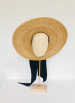 oversized wide brimmed natural straw extra large boater hat with large black moire ribbon bow with long tails