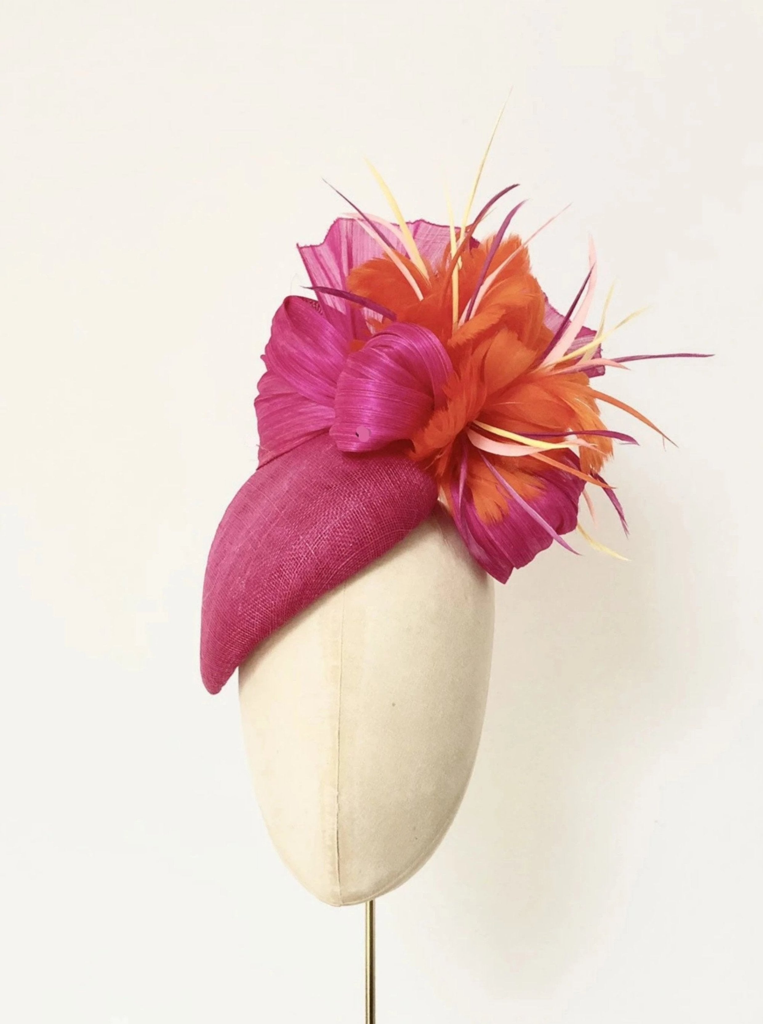 hot pink bright orange pillbox fascnator hat for weddings and royal ascot, silk abaca and feather flower finish