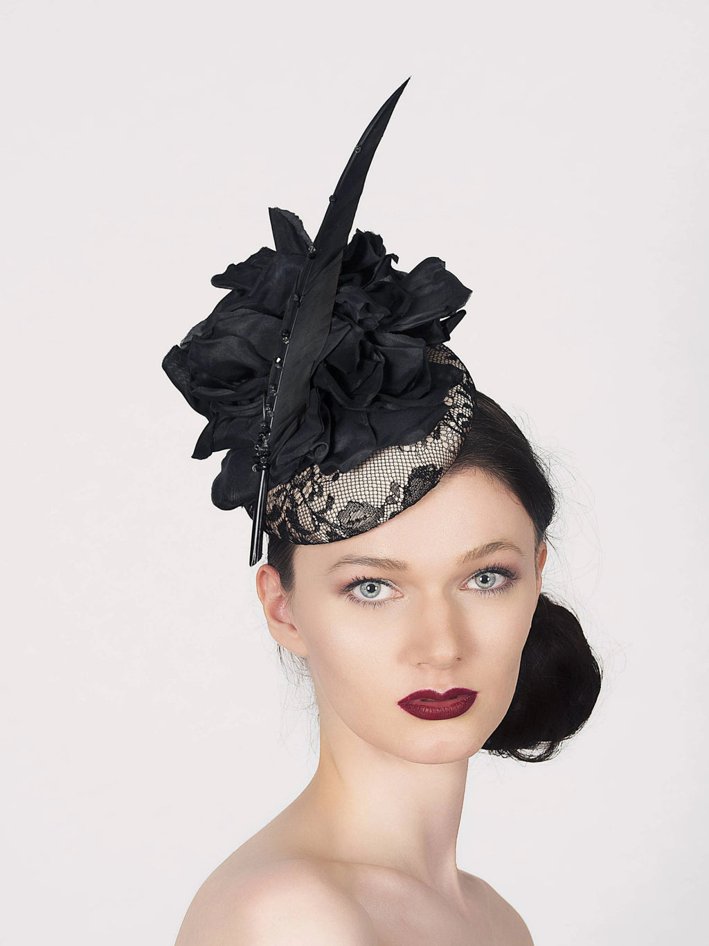 neutral and black lace pillbox fascintor wedding hat with large black silk flower and sharp black fetaher with crystals