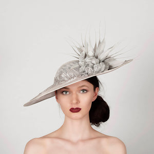 silver grey disc saucer fascinator hat, ideal for mother of the bride wedding hat, with lace band silk flower and spikey feather trim