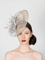 silver grey disc saucer fascinator wedding hat, with feather spray trim and metallic silver quills