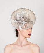 silver grey disc saucer fascinator wedding hat, with feather spray trim and metallic silver quills