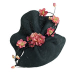 black wavy fascintor hat, with pink flowers, ideal for royal ascot