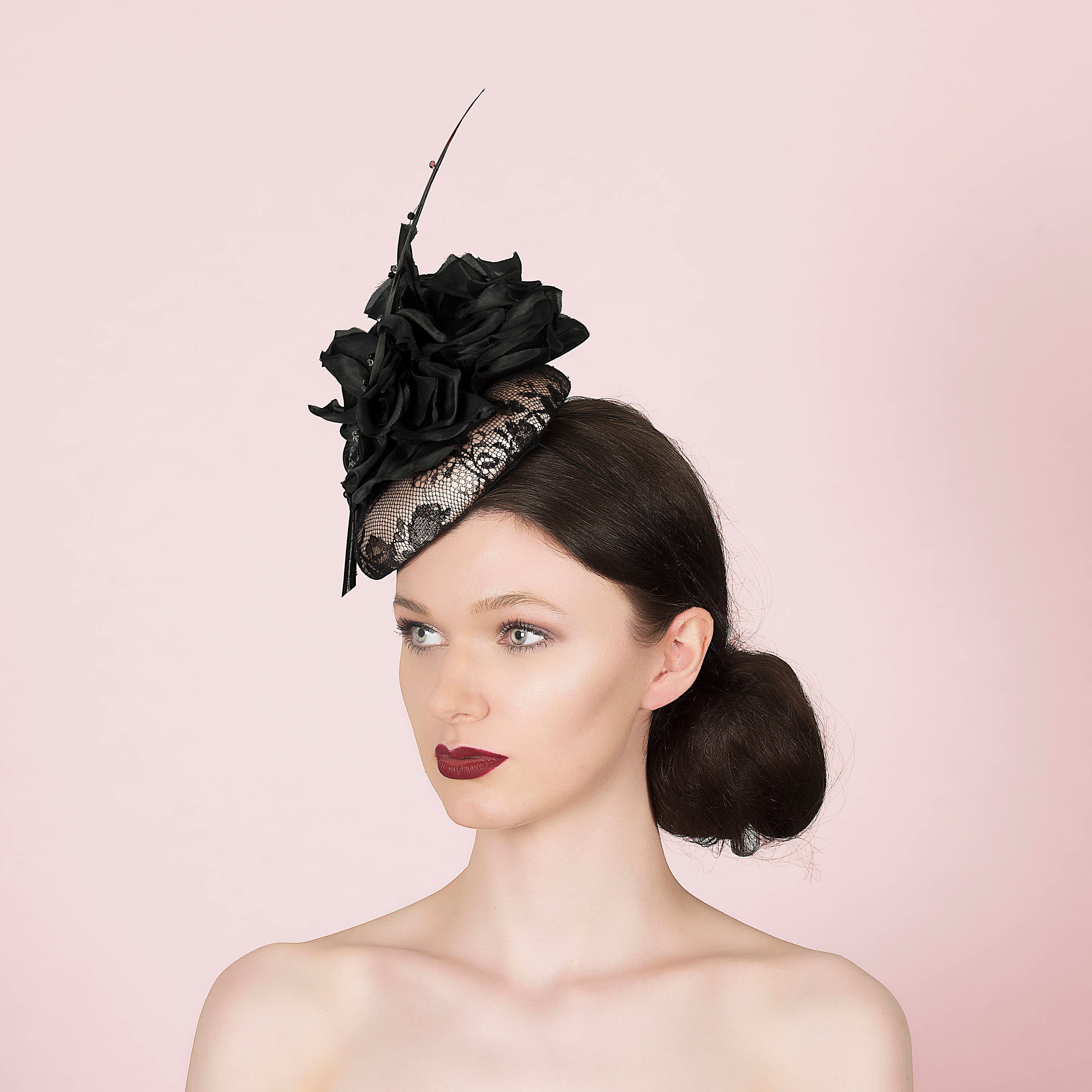 neutral and black lace pillbox fascintor wedding hat with large black silk flower and sharp black feather with crystals