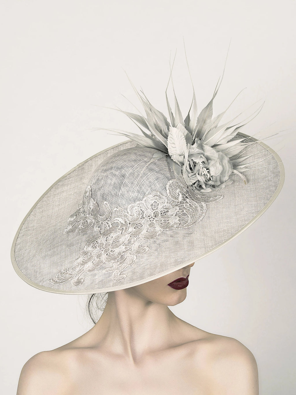 silver grey disc saucer fascinator hat, ideal for mother of the bride wedding hat, with lace band silk flower and spikey feather trim