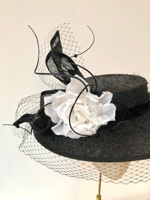 black knotted straw wide boater hat for ladies, royal ascot races, with white silk flower starw sinamy twist, black quills and black veiling
