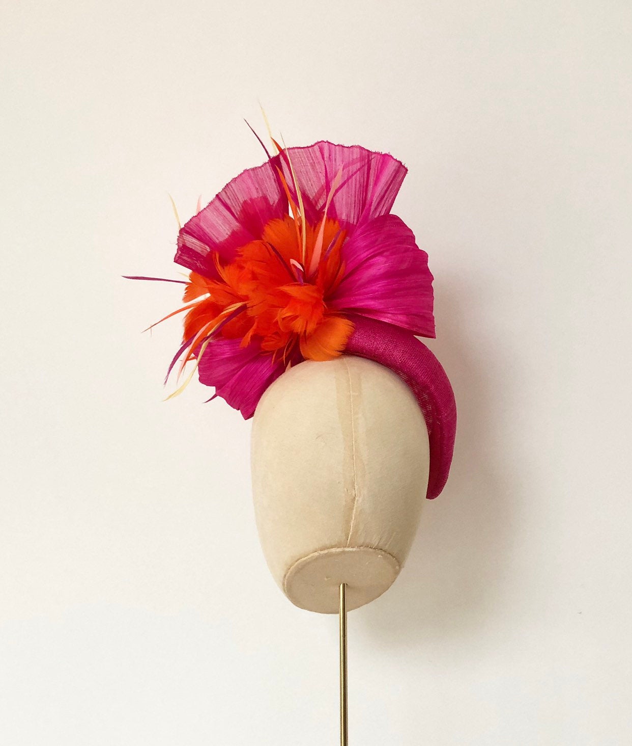 hot pink bright orange pillbox fascnator hat for weddings and royal ascot, silk abaca and feather flower finish