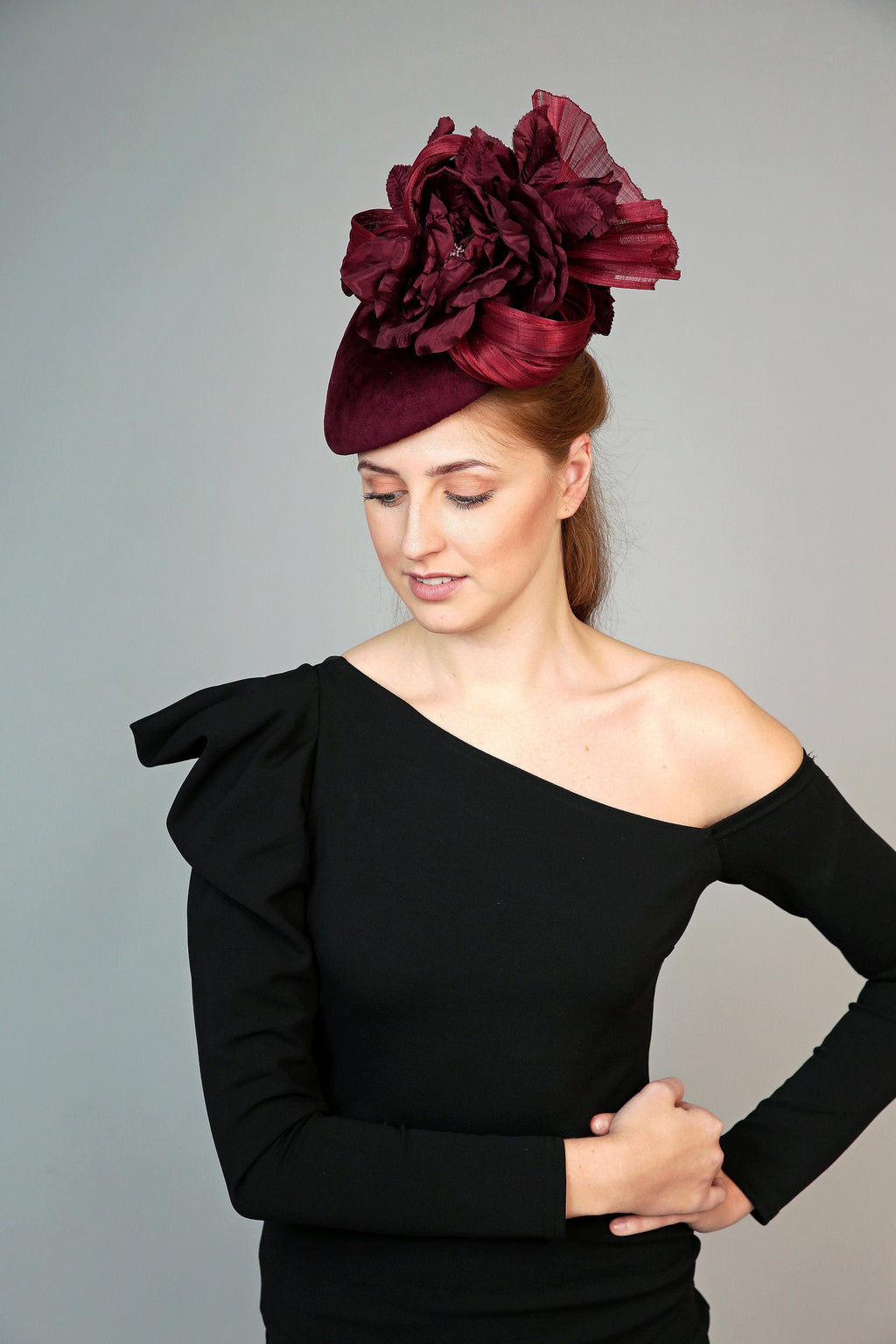 burgundy velvet teardrop fascinator hat, ideal for winter weddings, with large silk flower and silk abaca loops