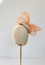 natural button cocktail hat with orange and yellow veiling bow, ideal for Royal Ascot, wedding hat