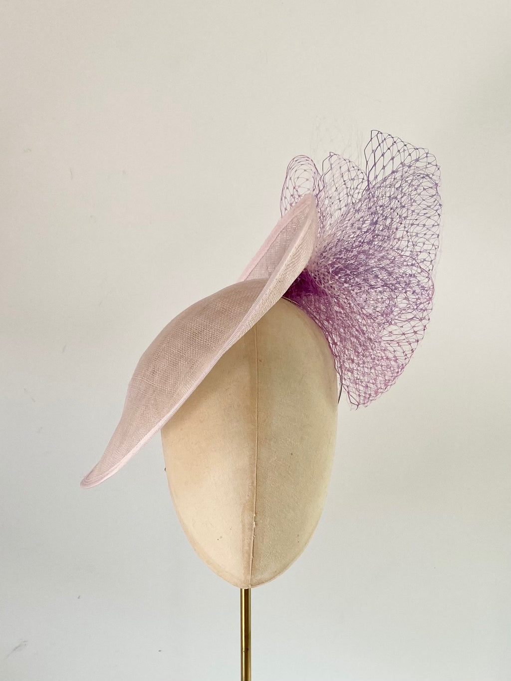 pale pink disc hat with lavender and lilac veiling bow