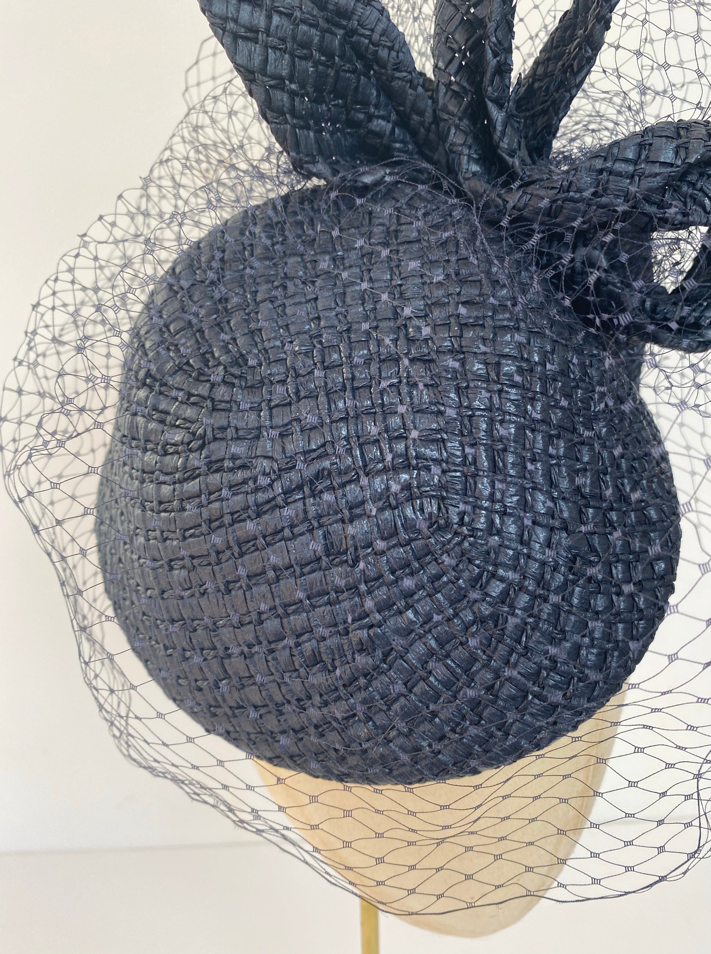 navy hat with birdcage veiling