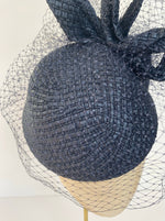 navy hat with birdcage veiling